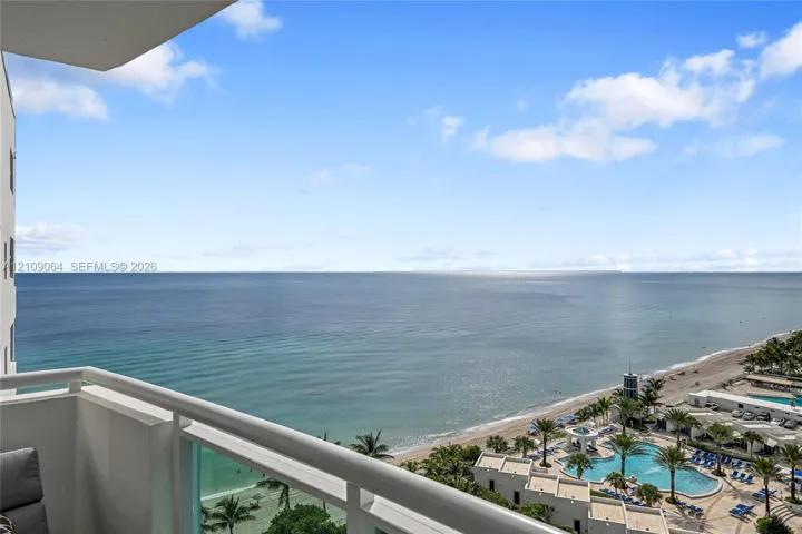 Private balcony featuring a metal railing and glass paneling with an expanse of ocean scenery