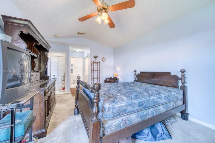 Vaulted ceiling featuring a ceiling fan with integrated lighting