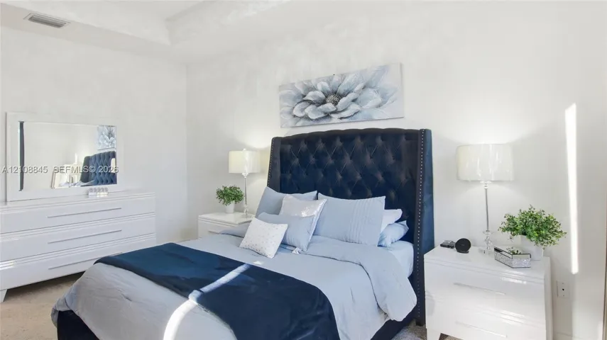 Tray ceiling with recessed lighting and neutral wall finish