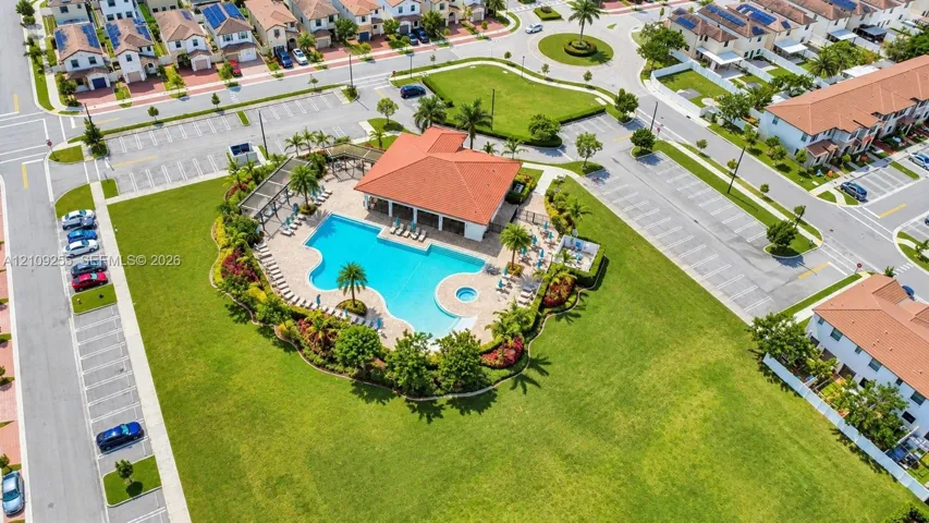 Community amenities featuring a swimming pool, integrated spa, covered pavilion, and landscaped grounds