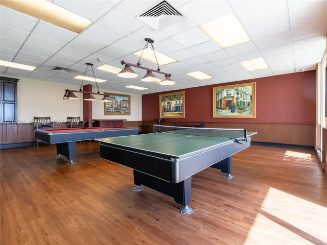 Recreation room featuring wood-finish flooring, a billiard table, a ping pong table, and track lighting