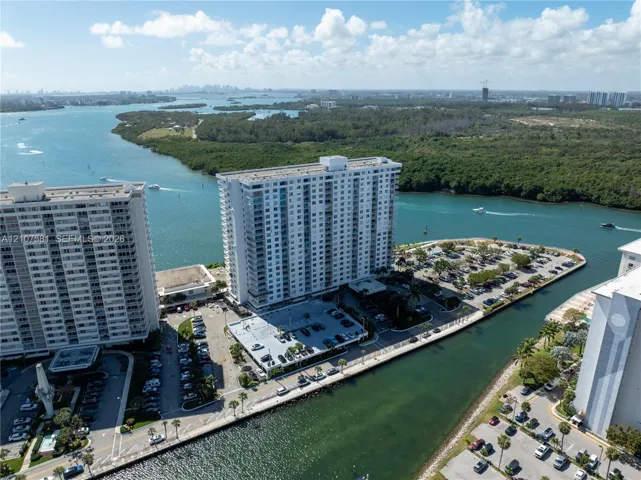 Waterfront property featuring multiple high-rise buildings and expansive surface parking areas