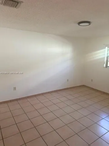 Interior space featuring neutral wall tones, ceramic tile flooring, and a flush-mount ceiling light fixture