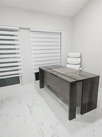 Polished white tile flooring with grey veining, dual windows, and adjustable horizontal window shades
