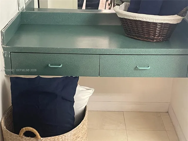 Wall-mounted vanity featuring solid-surface countertop and dual integrated drawers with metal pulls