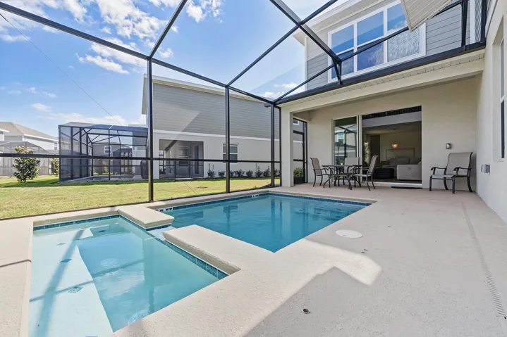 Screened-in pool and integrated spa, concrete deck, and siding exterior