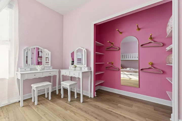 Vinyl wood-finish flooring, recessed alcove with built-in shelving, arched wall-mounted mirror, and brass-tone hardware