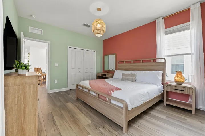 Vinyl wood-finish flooring, textured pendant lighting, and dual-panel closet doors