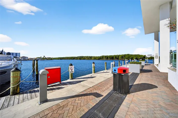 Waterfront promenade featuring herringbone-patterned paver walkways, concrete bulkhead, and deep-water boat docking capabilities