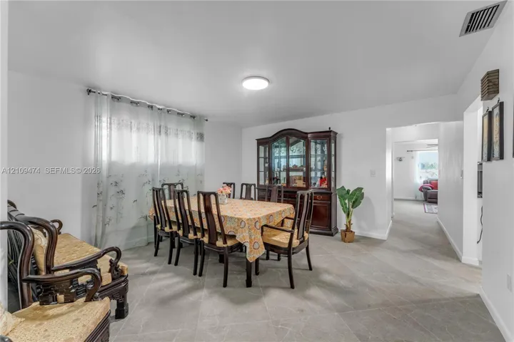 Neutral-toned tile flooring throughout the open-plan area