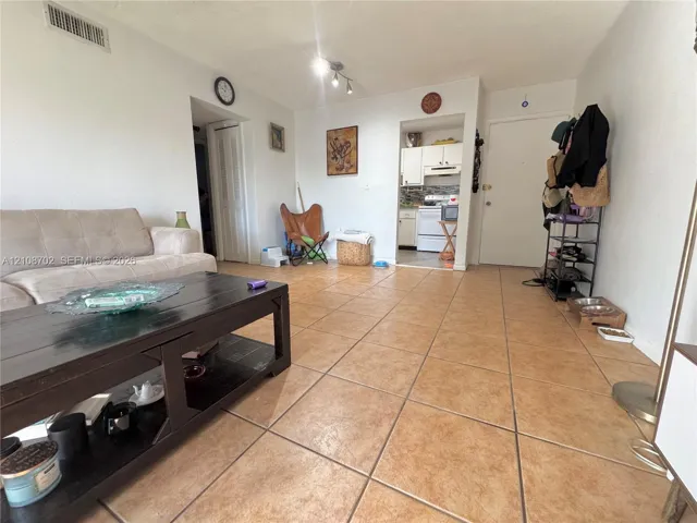 Open-concept interior featuring large-format tile flooring and recessed ceiling lighting