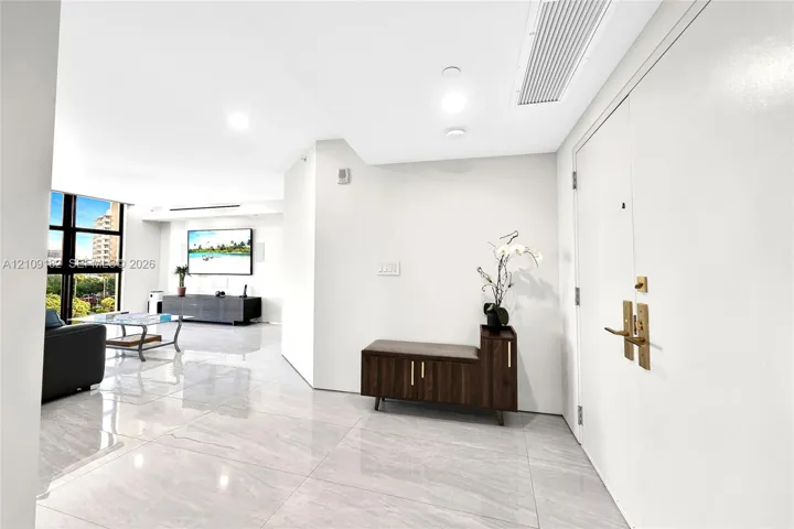 Polished stone-finish flooring, floor-to-ceiling windows, and recessed lighting