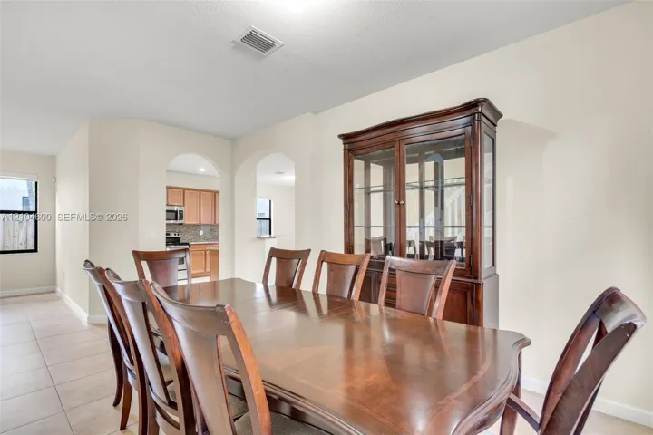 Dining area featuring tile flooring and two arched structural openings