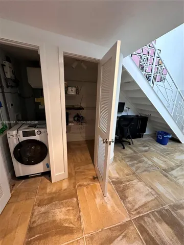 Porcelain tile flooring, built-in laundry area, and integrated storage closet