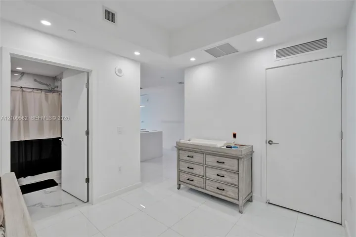 Polished tile flooring, recessed ceiling lighting, and solid-core interior doors