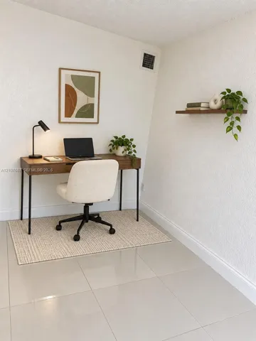 Neutral tile flooring and wall-mounted wooden shelving