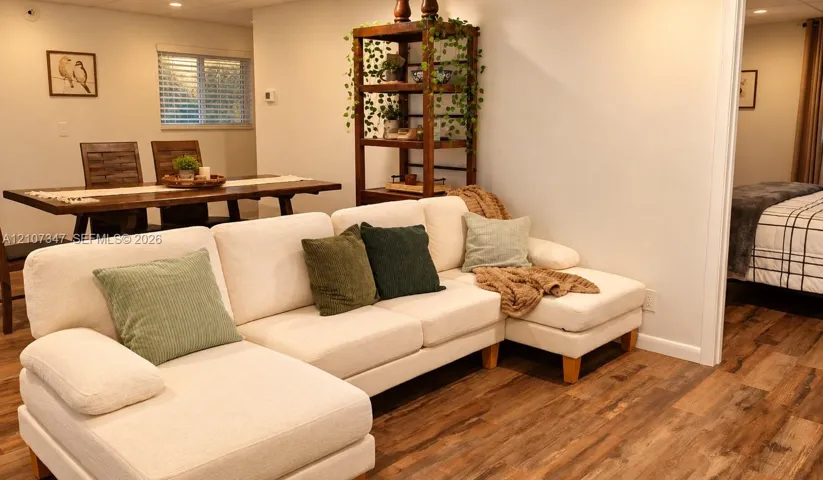 Wood-finish flooring, recessed lighting, and white interior wall paint