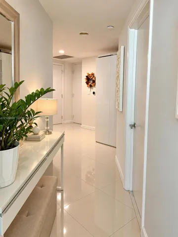 Polished tile flooring, neutral wall finishes, and multiple interior door access points