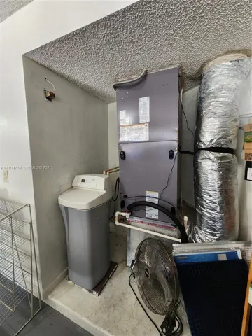 Mechanical area featuring a climate control air handler unit and a water softening system