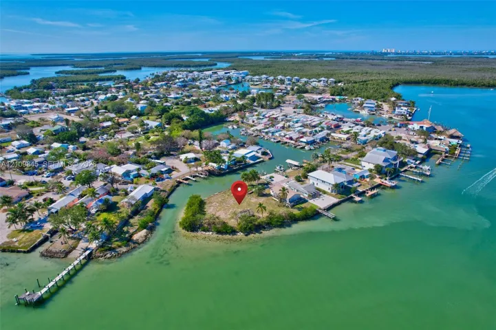 Waterfront parcel featuring direct canal access, a coastal location, and mature tropical vegetation