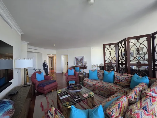 Spacious interior featuring hardwood flooring, intricate crown molding, and recessed lighting