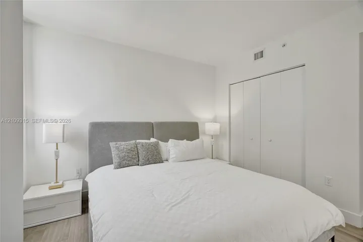 Neutral interior with wood-finish flooring and bi-fold closet doors