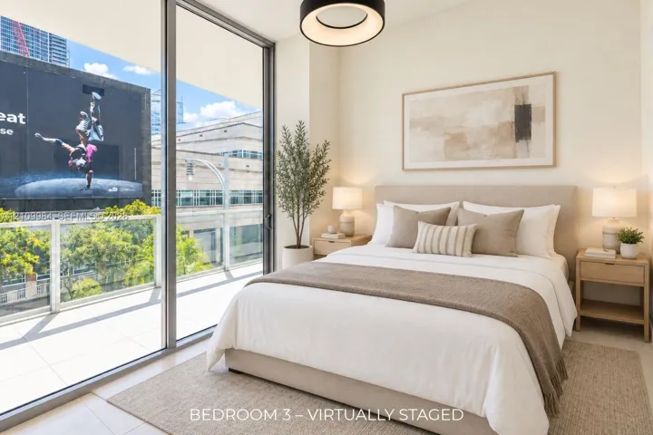 Floor-to-ceiling sliding glass doors, tile flooring, glass-paneled balcony railing, and modern circular pendant lighting