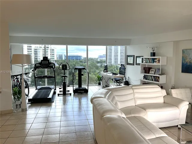 Open-concept interior featuring large-format ceramic tile flooring and expansive floor-to-ceiling windows