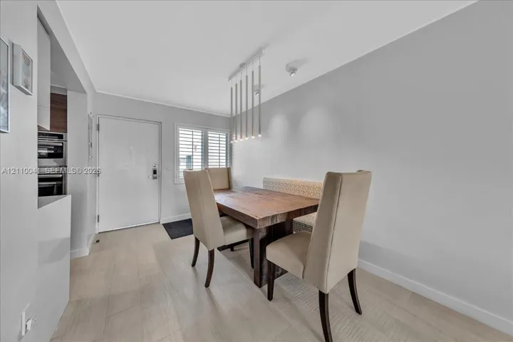 Wood-finish flooring, multi-pendant linear light fixture, and window shutters
