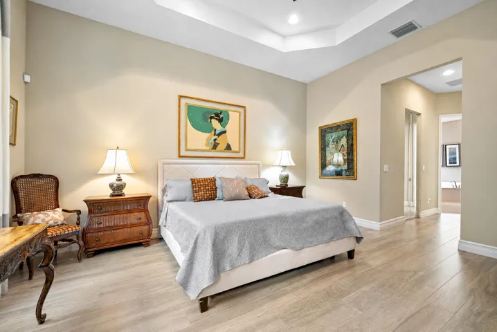 Tray ceiling, recessed lighting, and wood-finish flooring