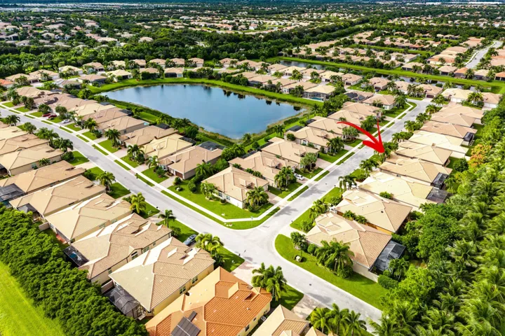 Aerial perspective featuring tile roofing, concrete paved streets, and residential landscaping within a suburban community