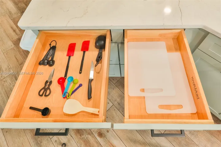 Custom wood-dovetail cabinetry drawers with stone countertops, undermount hardware, and integrated pulls