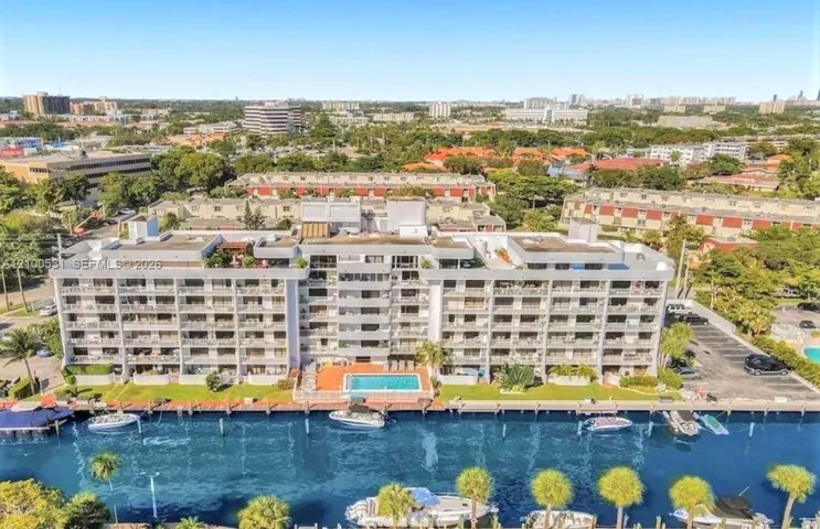 seven story building with large private balconies, waterfront access, marina, and a swimming pool
