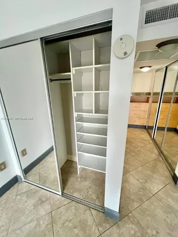 primary bedroom has multiple custom closets throughout