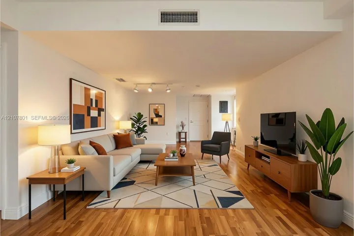 VIRTUALLY STAGED - Open interior space featuring wood-finish flooring, recessed lighting, and adjustable track lighting