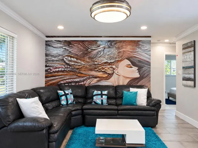 Interior space featuring crown molding, neutral wall finishes, tile flooring, and a flush-mount drum ceiling light fixture