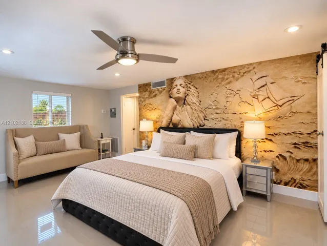 Room featuring a large-scale sculpted relief wall art, polished tile flooring, recessed lighting, and a brushed nickel ceiling fan