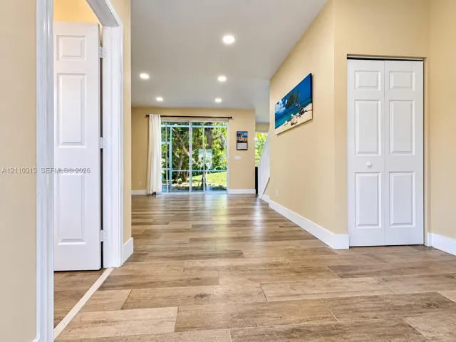 Interior space featuring wood-finish flooring, recessed lighting, and sliding glass doors with exterior outdoor exposure