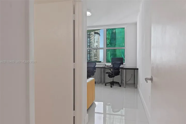 Polished tile flooring, large multi-pane windows, and a flush-mount ceiling light fixture