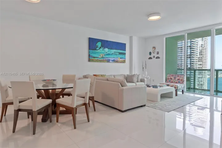 Polished porcelain tile flooring, floor-to-ceiling glass sliding doors, and recessed ceiling lighting