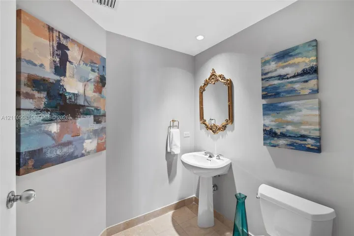 Pedestal sink with polished chrome faucet, tile flooring, and recessed lighting
