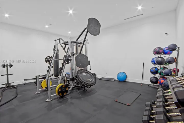 Spacious room featuring resilient rubber flooring and recessed ceiling lighting