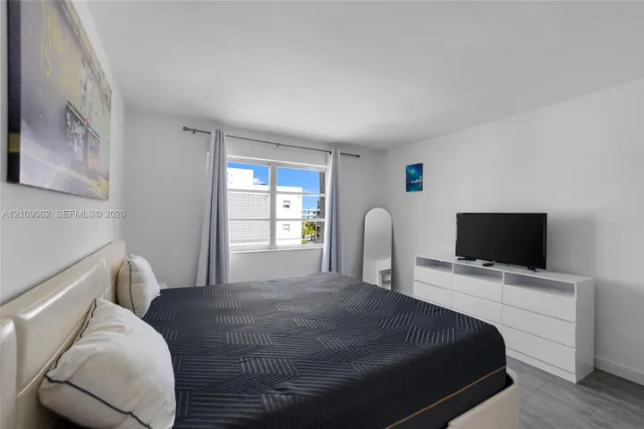 Room featuring neutral wall paint, horizontal slider window, and gray-toned flooring