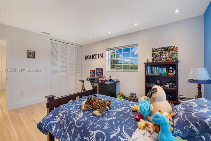Light-filled room featuring wood-finish flooring, recessed lighting, and a multi-pane window