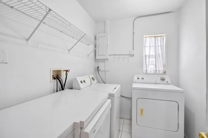 Utility room off kitchen - dishwasher, washer, dryer. AI used to clear personal belongings