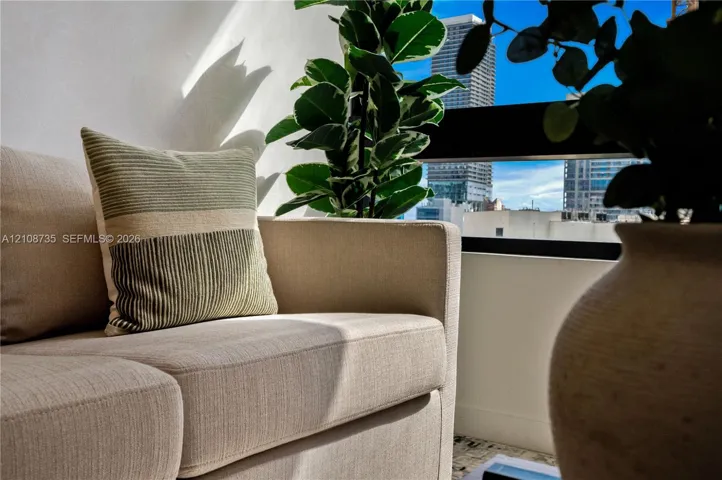 Horizontal window featuring a black frame and urban city skyline backdrop