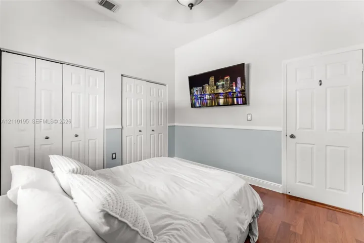 Vaulted ceiling, wood-finish flooring, two sets of bi-fold closet doors, and chair rail molding