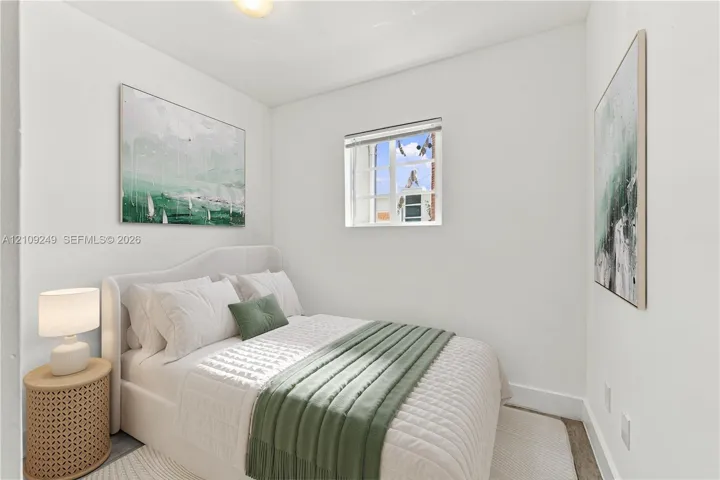 Neutral interior featuring white walls, a single-pane multi-light window, and a flush-mount ceiling fixture