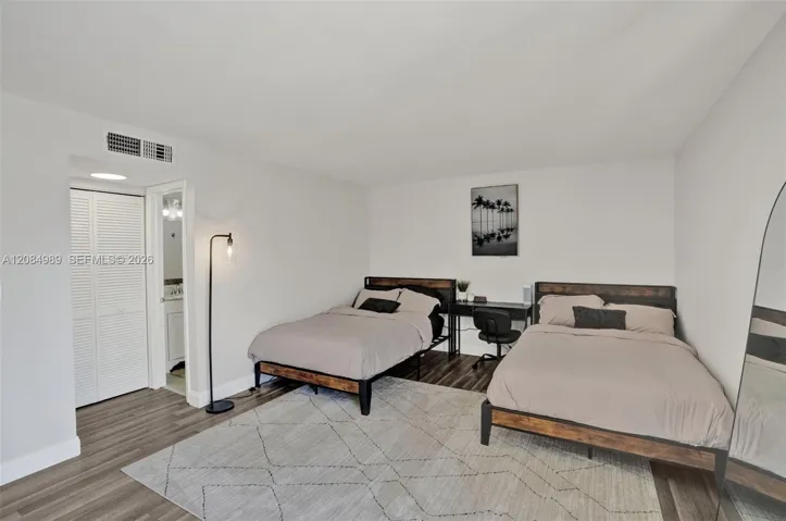 Room featuring wood-finish flooring and a double-door closet