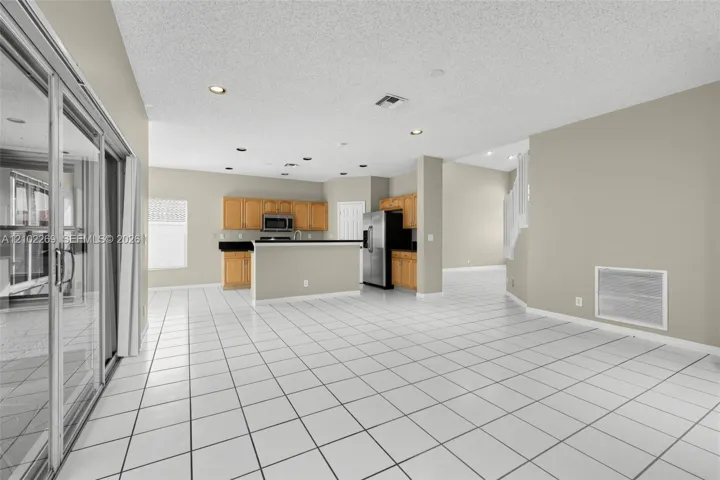 Kitchen featuring wood cabinetry, stainless steel appliances, and a breakfast bar